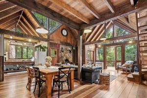a kitchen and living room with a table and chairs at Rustic 3-Bed Retreat in Springbrook in Springbrook