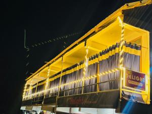 a yellow building with lights on the side of it at Delight Homestay Gulmarg in Gulmarg