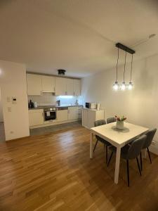 a kitchen and dining room with a table and chairs at SeePERLE 131 in Friedrichshafen