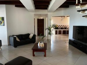 a living room with a couch and a coffee table at Paradise Beach House in Vilanculos