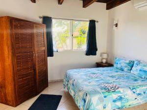 a bedroom with a large bed and a window at Paradise Beach House in Vilanculos +8 photos