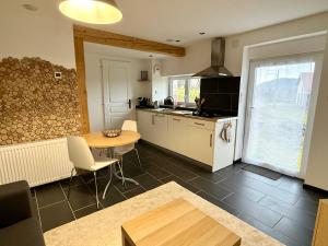 a kitchen and dining room with a table and a table at La Bulle d Avenir in Corcieux