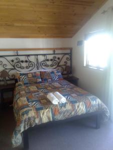 a bed with a quilt and pillows in a bedroom at Soloko Game farm in Kareedouw