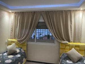 a room with a window with a couch and a bed at Villa haut standing vue mere in Kenitra