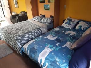 a bedroom with two twin beds and a bedspread with polar bears at DURBUY RESIDENCE -A201- in Durbuy +25 photos