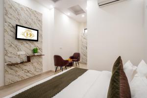 a bedroom with a bed and a tv on a wall at Hotel Delhi 53 Near ISBT Kashmiri Gate in Delhi