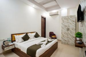a bedroom with a large bed and a television at Hotel Delhi 53 Near ISBT Kashmiri Gate in Delhi