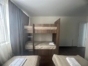 a room with two bunk beds in a room at Mini hotel falcon in Bakuriani