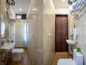 a bathroom with two sinks and a shower at Hotel Delhi 53 Near ISBT Kashmiri Gate in Delhi +100 photos