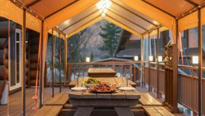 a table on a screened porch with a bowl of food at Daecheon Ocean Forest Pension in Boryeong