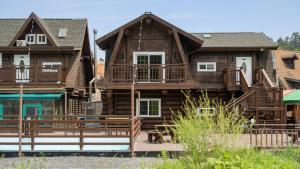 a large wooden house with a porch and a deck at Daecheon Ocean Forest Pension in Boryeong