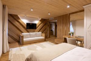 a bedroom with a bed and a desk and a television at Prispa Premium Resort in Vişeu de Sus +67 photos