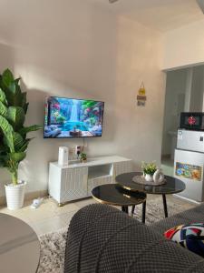 a living room with a flat screen tv on the wall at Zuribreezhomes in Bamburi