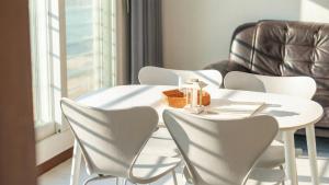 a white table and chairs in a room with a window at GoSeong Beach Jin Spa Pension in Goseong +10 photos