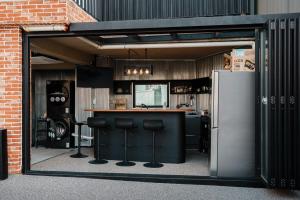 a bar with black stools in front of a building at Original Backpackers in Seoul +30 photos