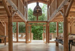 a large wooden barn with a large window and a pendant light at Journeyman in Bromyard +1 photo