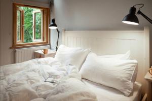 a white bed with pillows and a book on it at Journeyman in Bromyard