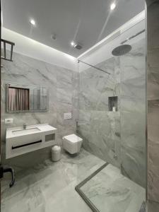 a bathroom with a toilet and a sink and a shower at Hotel Dragoi in Velipojë +37 photos