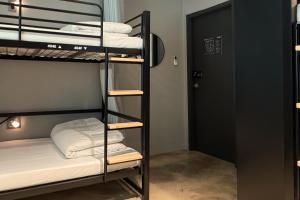 a room with two bunk beds and a door at Original Backpackers in Seoul
