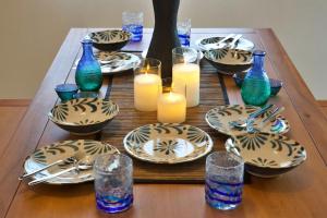 a wooden table with plates and candles on it at Sunstone GINOWAN 1F in Futemma