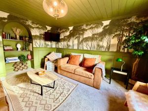 a living room with a couch and a table at Style 3BR House Jameston | Garden | Near Tenby in Tenby