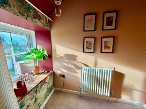 a corner of a room with a radiator and a window at Style 3BR House Jameston | Garden | Near Tenby in Tenby +35 photos