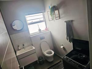 a small bathroom with a toilet and a sink at Quarter 5, Two Zero Four in Oakdale