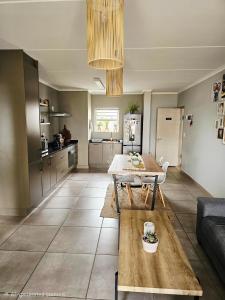 a living room with a table and a kitchen at Quarter 5, Two Zero Four in Oakdale