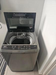 a washer and dryer in a corner of a room at Quarter 5, Two Zero Four in Oakdale