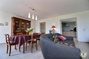 a living room with a table and a blue couch at Ker illis in Lannion