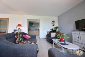 a living room with a couch and a table at Ker illis in Lannion
