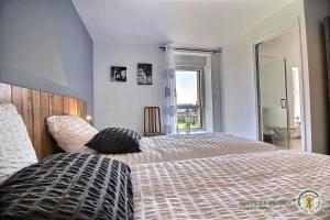 a bedroom with a bed and a large window at Ker illis in Lannion