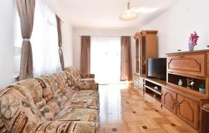 a living room with a couch and a television at Villa Cascata in Trilj