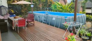 a deck with a swimming pool and a hot tub at Vimalla Hills 2br Private pool, bebas Jam cekin, cekout sesuai jam cekin 24 jam,081tiga80satu6415satu in Gadok 1