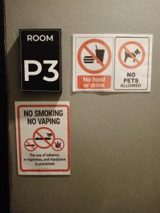 three signs on the wall of a room at Thesleeperhomestay in Ban Chuk Kum