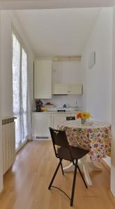 a kitchen with a table and a chair in a room at Jolly Roger Riomaggiore in Riomaggiore +27 photos
