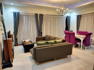 a living room with a couch and a table at Vimalla Hills 2br Private pool, bebas Jam cekin, cekout sesuai jam cekin 24 jam,081tiga80satu6415satu in Gadok 1