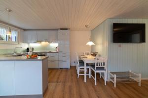 a kitchen and dining room with a table and chairs at Studio Muerner in Wildhaus