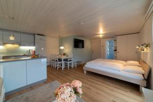 a kitchen and a bedroom with a bed in a room at Studio Muerner in Wildhaus