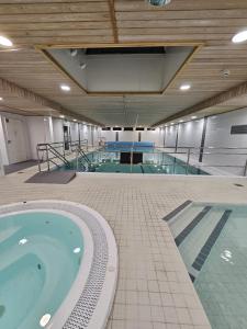 una grande piscina coperta con due piscine di Kylpylähotelli Pohjanranta a Keminmaa