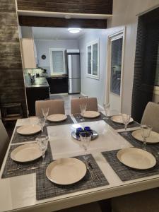 a dining room table with plates and glasses on it at Villa Sara in Kalajoki
