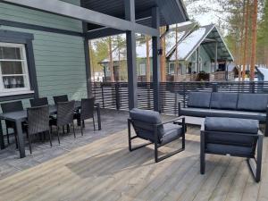 a patio with chairs and tables and a building at Villa Sara in Kalajoki +9 photos