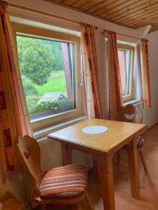 a table and chairs in a room with a window at Ferienhaus Julia in Admont