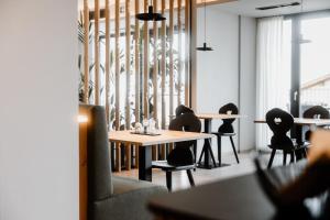 a dining room with a table and chairs at Stricker Aparthotel in Tirolo