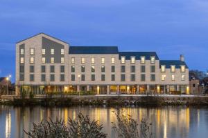 a large building next to a body of water at AC Hotel by Marriott Inverness in Inverness