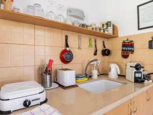 a kitchen with a counter top with a sink at Cute apartment hagoshrim in HaGoshrim +10 photos