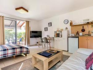 a living room with a couch and a table and a kitchen at Cute apartment hagoshrim in HaGoshrim