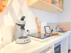 a kitchen counter with a mixer on a counter top at Le Balinais - Esprit Bali, Centre-ville & Unique in Saint-Brieuc