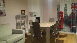 a living room with a wooden table and chairs at Affitti brevi Liguria - La Conchiglia in Savona