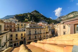 a view of a city with mountains in the background at Zia Pupetta Suites in Amalfi